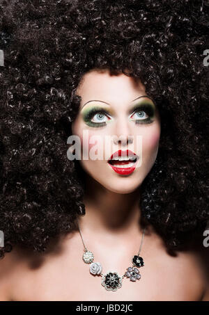 Creativity. Theatrical Emotions. Woman with Fantastic Coiffure looks like Doll Stock Photo