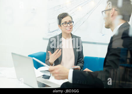 Confident economists discussing financial data at meeting Stock Photo