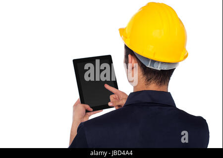 Young construction worker operating touch pad device Stock Photo
