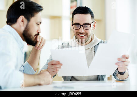 Young economists discussing documents at work Stock Photo