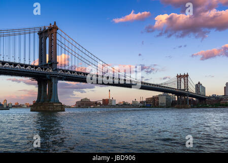 Manhattan Bridge (long-span suspension bridge) over the East River at sunset with view of Brooklyn. New York City