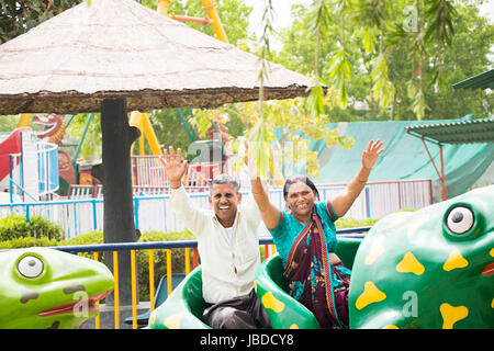 2 Indian Senior Couple Fair Ride Vacations Holidays Stock Photo