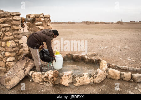 Chris Huby / Le Pictorium -  Syria / Rojava - Wrath of the Euphrates -  31/12/2016  -  Rojava  -  SYRIA - ROJAVA - Dec16 and Janv17 - Ahmed, a father, fills water seals for his home. Stock Photo