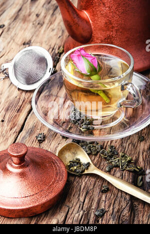 copper kettle, tea rose buds and a cup of herbal tea Stock Photo