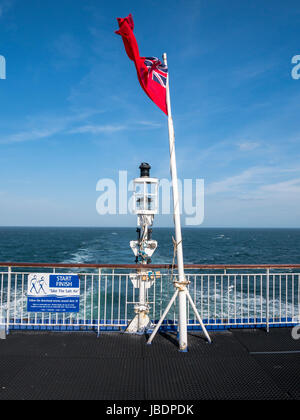 Red Ensign flag on stern of Fishguard to Rosslare ferry. Stock Photo