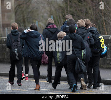 Anonymous school children in Scotland take time out during lunch break Stock Photo