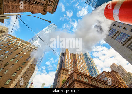 Looking up at Manhattan skyscrapers with steam coming from street pipe, New York City, USA. Stock Photo