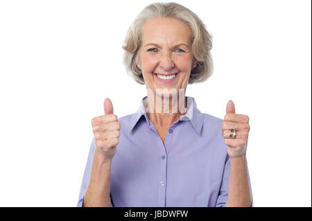 Smiling old lady showing double thumbs up Stock Photo