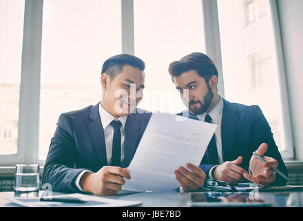 Two managers discussing contract in meeting room Stock Photo
