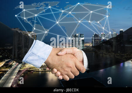 Deal or agreement business concept, handshake double exposure, cooperation or partnership business with global connection partnership map. Stock Photo
