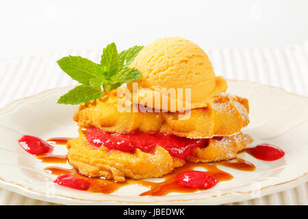 Spritz cookies with raspberry sauce and ice cream Stock Photo