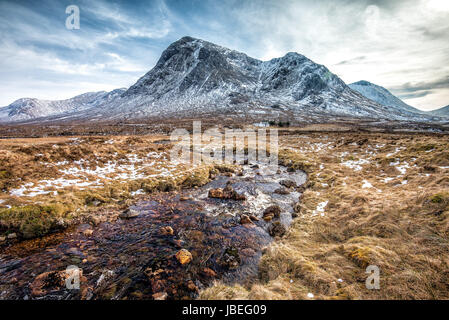 small house in front of a mountain with stream Stock Photo