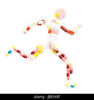 Doping drugs and pills in the shape of an athletic runner on track. Stock Photo