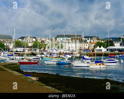 Sailboats moored in harbor outside walls of medieval Concarneau, France Stock Photo