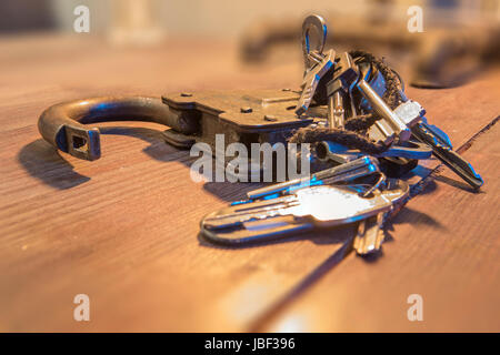 An old padlock with a bunch of keys on a rope. Stock Photo