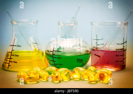 Oil capsules and flask chemical Stock Photo