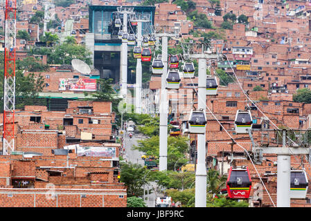 MEDELLIN, COLOMBIA - MARCH 8: Metrocable cars arriving at a station in Medellin, Colombia on March 8, 2014.  Metrocable is the first gondola lift system in the world dedicated to public transportation. Stock Photo