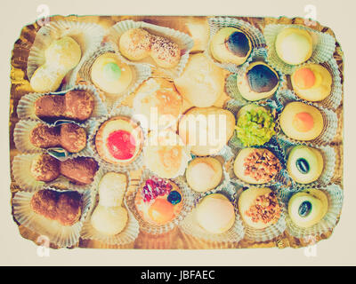 Vintage retro looking Mixed pastries with chocolate, cream, fruit useful as background Stock Photo