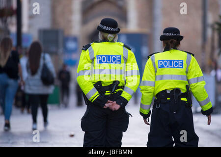 Two female police officer women walking on patrol in cardiff, wales. Stock Photo