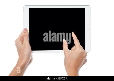 Womans fingers pointing on tablet screen Stock Photo