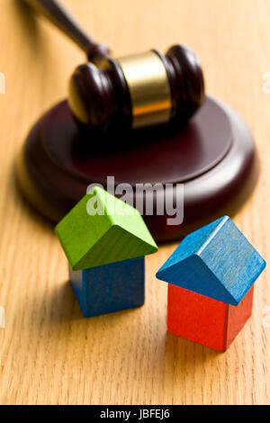 the wooden house and judge gavel on wooden table Stock Photo