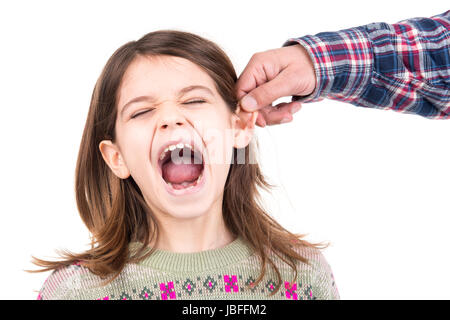 Young girl being punished with ear pulling Stock Photo