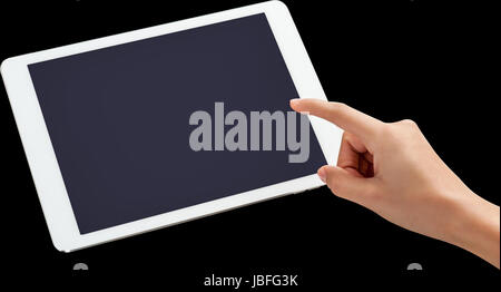 Womans finger pointing on tablet screen Stock Photo