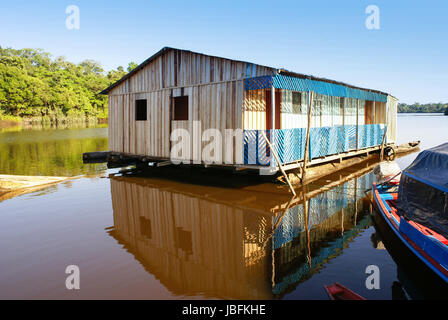 Houses on stilts rise above the polluted water in Islandia Peru Stock Photo
