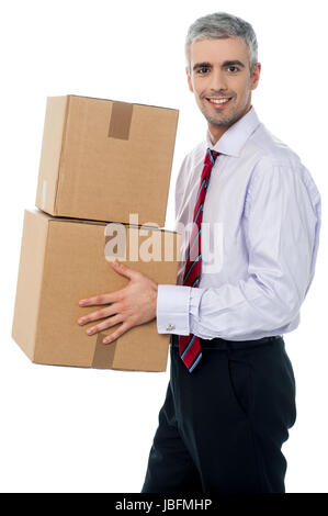 Middle aged man holding stack of parcel boxes Stock Photo