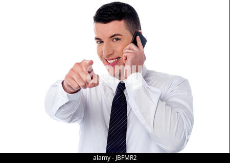 Businessman communicating through mobile and pointing you Stock Photo