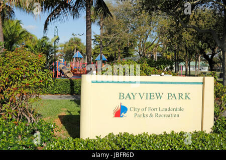 FORT LAUDERDALE, FLORIDA - FEBRUARY 23, 2014: Bayview Park sign, located on Bayview Drive in the upscale neighborhood of Coral Ridge Country Club Estates with playground equipment, trees and nature. Stock Photo