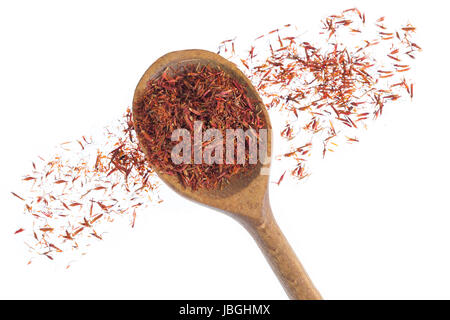 Saffron stamens in the wooden spoon, Spread on white Stock Photo