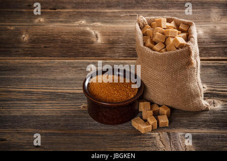 Brown cane sugar cubes in burlap sack Stock Photo