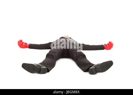 businessman was punched with boxing gloves and lie down on the floor. Stock Photo