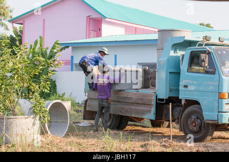 Building workers with large concrete pipes Stock Photo