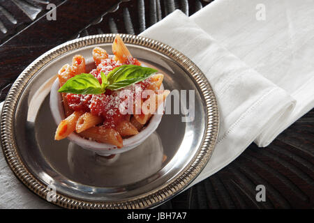 Pasta with tomato sauce in a very small bowl Stock Photo