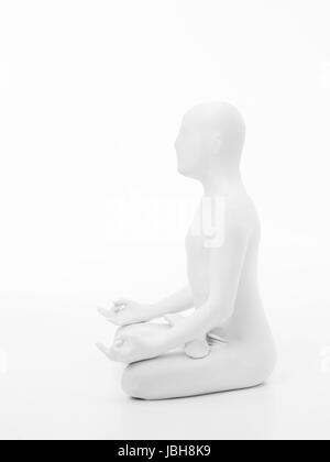 faceless man dressed in white sitting in yoga lotus position, side view Stock Photo