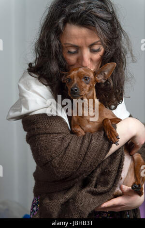 woman is holding her dog Stock Photo