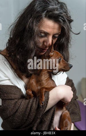 woman is holding her dog Stock Photo