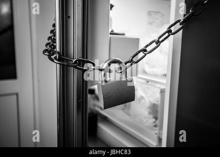 locks on a refrigerator door to keep someone on their diet Stock Photo -  Alamy
