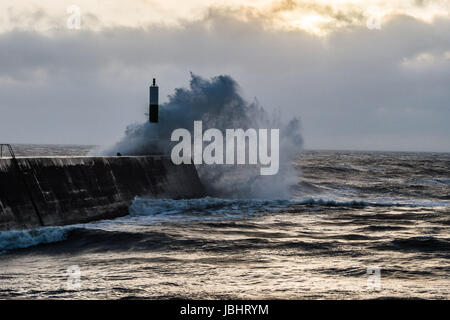 Aberystwyth Wales UK, Sunday 11 June 2017 UK Weather: Unseasonal gale force winds and high tides combine to bring huge waves crashing into the sea defences in Aberystwyth, Wales at the end of the day photo Credit: Keith Morris/Alamy Live News