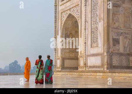 Tourists standing outside Taj Mahal in Agra, Uttar Pradesh, India. Taj Mahal was designated as a UNESCO World Heritage Site in 1983. Stock Photo