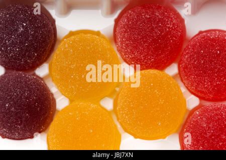 Round jelly sprinkled with sugar in a plastic box Stock Photo