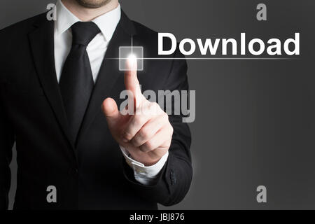 man in black suite pressing virutal button download Stock Photo