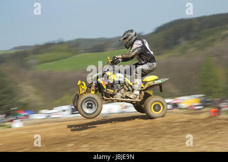 MOHELNICE,  CZECH REPUBLIC - APRIL 19: Racer is riding a yellow quad motorbike in the 'International Championship of the Czech Republic 2014' on April 19, 2014  in MOHELNICE, Czech Republic. Stock Photo