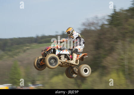 MOHELNICE,  CZECH REPUBLIC - APRIL 19: Racer is jumping a quad motorbike in the 'International Championship of the Czech Republic 2014' on April 19, 2014  in MOHELNICE, Czech Republic. Stock Photo