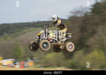 MOHELNICE,  CZECH REPUBLIC - APRIL 19: Quad racer is high jumping a motorbike in the 'International Championship of the Czech Republic 2014' on April 19, 2014  in MOHELNICE, Czech Republic. Stock Photo