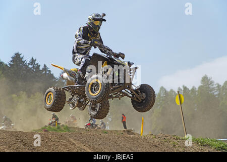 MOHELNICE,  CZECH REPUBLIC - APRIL 19: Racer with camera is jumping a quad motorbike in the 'International Championship of the Czech Republic 2014' on April 19, 2014  in MOHELNICE, Czech Republic. Stock Photo