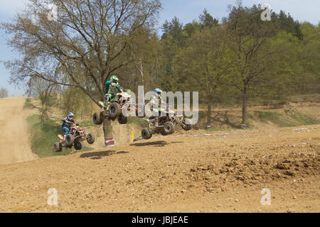 MOHELNICE,  CZECH REPUBLIC - APRIL 19: Trinity of quad riders are jumping a quad motorbike in the 'International Championship of the Czech Republic 2014' on April 19, 2014  in MOHELNICE, Czech Republic. Stock Photo