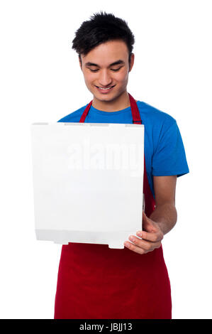 Smiling male chef holding an opened pizza box Stock Photo - Alamy